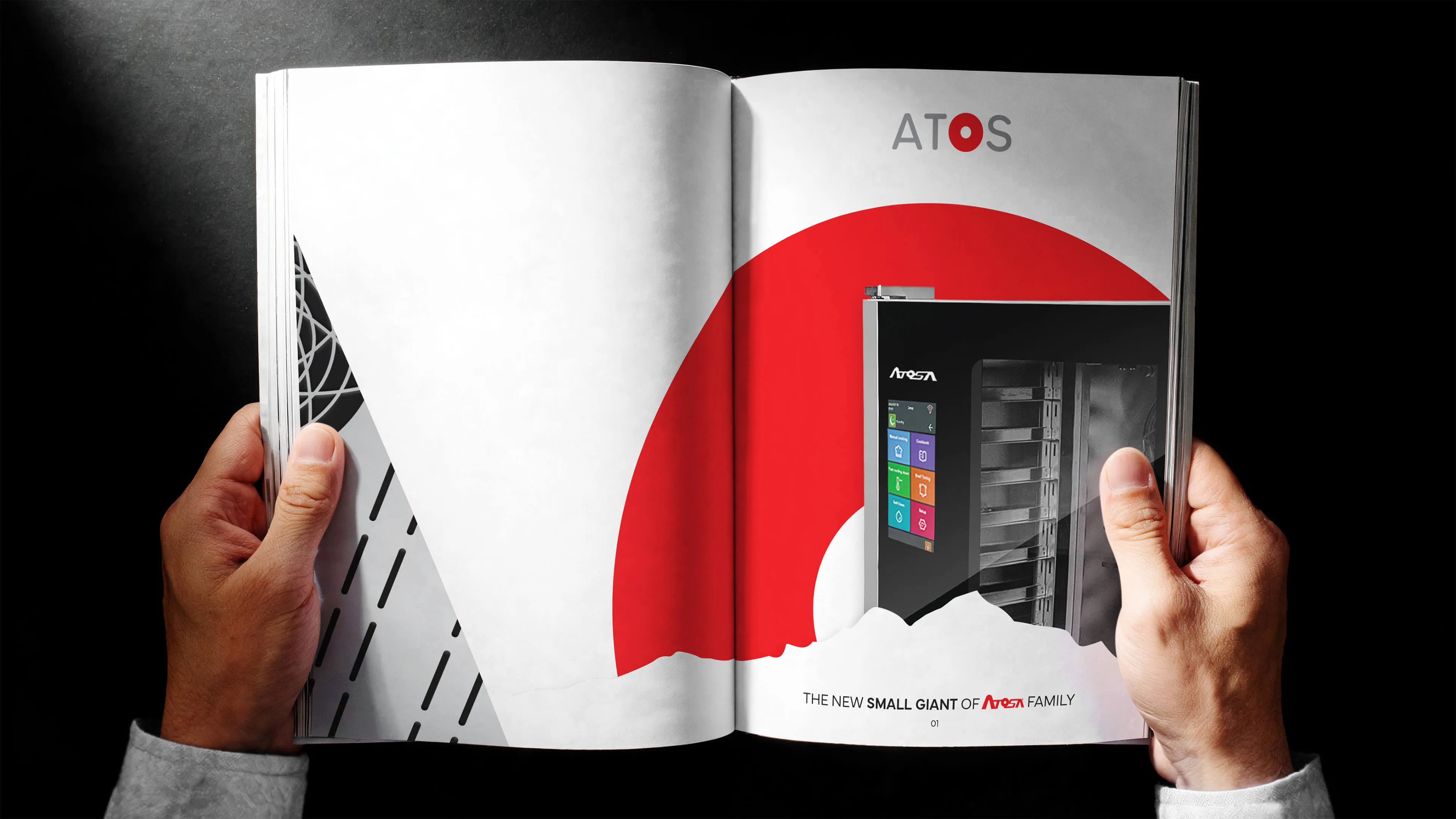 A person holding a catalogue open to a page with a red circular graphic and an image of an Atosa commercial kitchen appliance, with text reading 'THE NEW SMALL GIANT OF ATOSA FAMILY.'