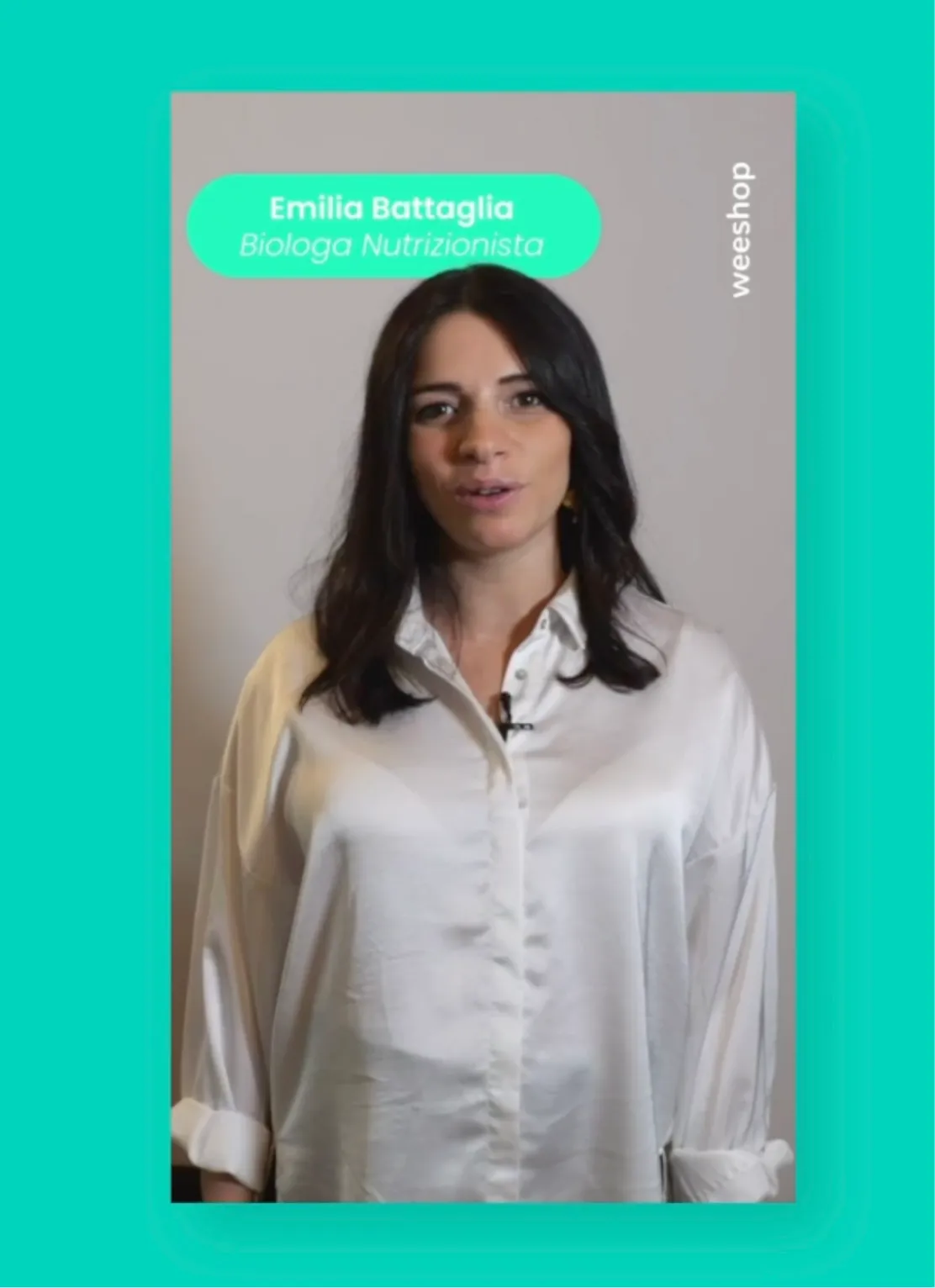 Woman with dark hair wearing a loose white button-up shirt standing against a plain background, with text above her that reads 'Emilia Battaglia Biologa Nutrizionista' and 'weeeshop' on the right side.