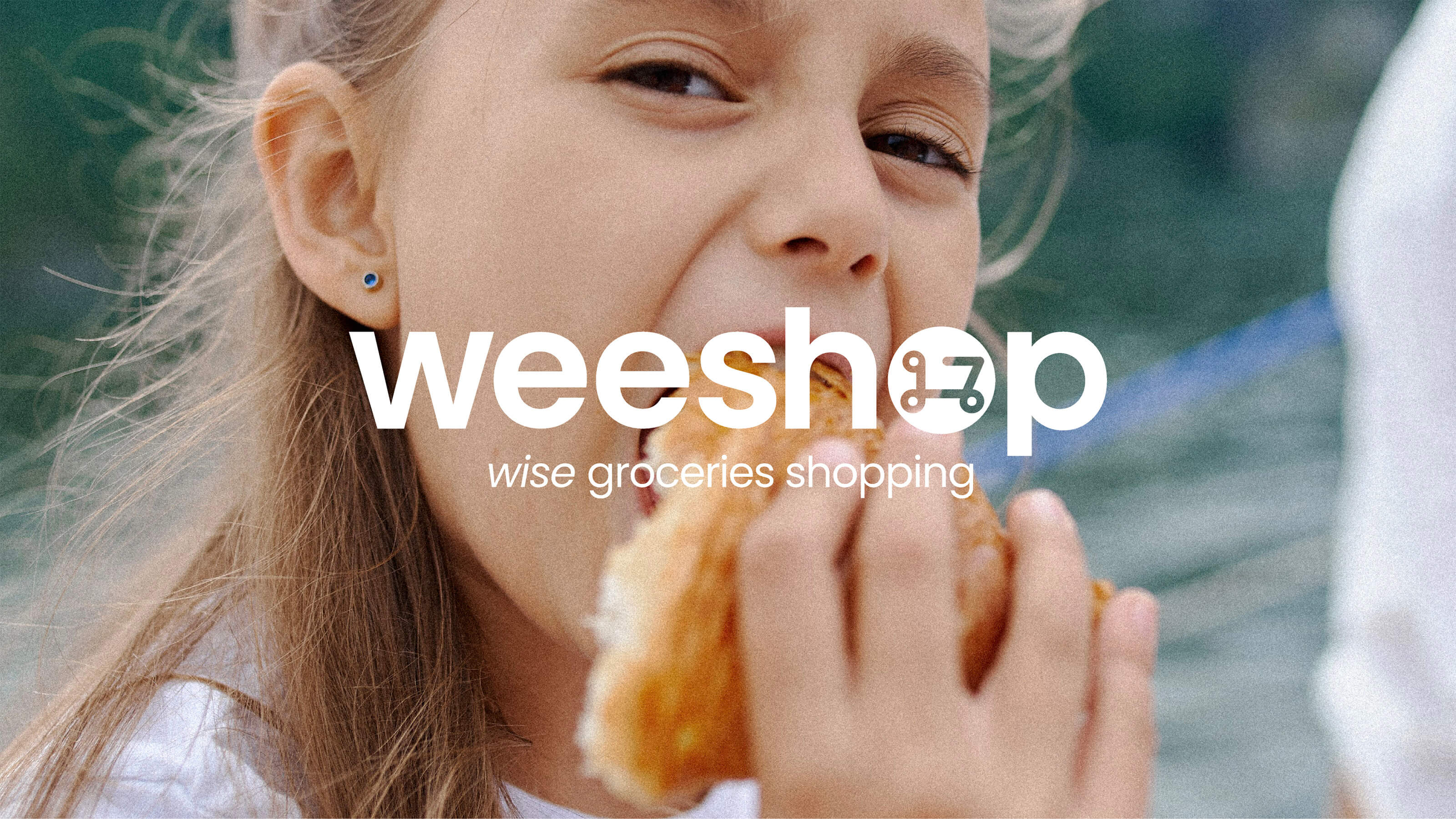 Close-up of a young girl with long brown hair eating a croissant outdoors with a green blurred background, overlaid with the text 'weeshop' and the tagline 'wise groceries shopping'.